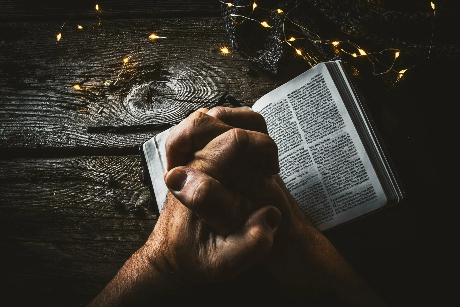 person holding book page with string lights person holding book page with string lights