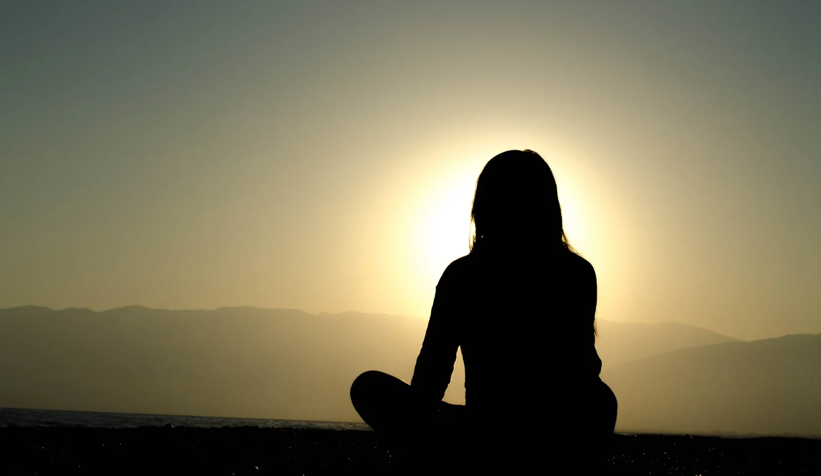  woman sitting on sand